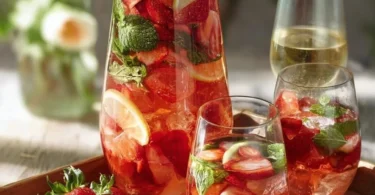 Erdbeer-Minz-Bowle in einem Glas mit frischen Erdbeeren und Minzblättern